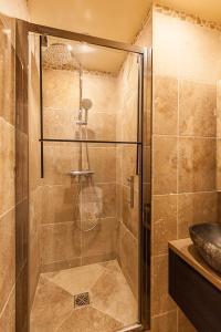 a shower with a glass door in a bathroom at Ty Gwened - Centre Historique - Calme - Wifi in Vannes +6 photos