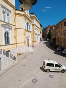a white van parked in the middle of a street at Cozy in Sarajevo