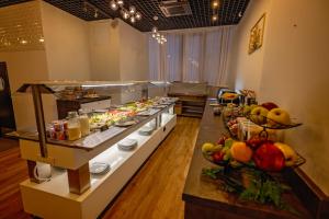 a buffet line with many different types of food at Opera Hotel in Timişoara