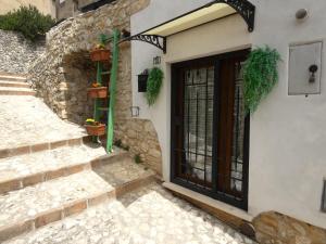 a door of a building with plants on it at SCAPPO IN UMBRIA, Vicoletto in Porchiano del Monte