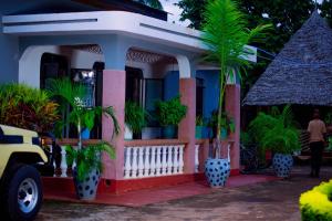 a small house with plants inront of it at The Better Inn in Moshi