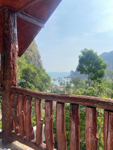 a wooden balcony with a view of the mountains at Garden View Resort Tonsai in Tonsai Beach