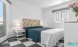 En eller flere senge i et værelse på Villa Paca