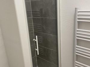 a bathroom door with a glass shower backdoor at Studio Aix-les-Bains, 1 pièce, 2 personnes - FR-1-617-23 in Aix-les-Bains