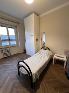 a bedroom with a bed and a table in it at Solferino 17 suites Brescia Stazione in Brescia