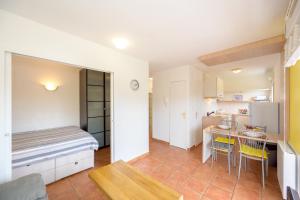 een klein appartement met een bed en een keuken bij Noz Vat - Appt pour 2 avec balcon in Plouha