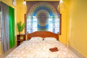 a bedroom with a large bed with a mural on the wall at La Casa Nostra in Luang Prabang +61 photos
