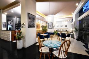 a dining room with a table and chairs at Somerset Berlian Jakarta in Jakarta