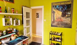 a kitchen with a yellow wall with a sign on it at Begutxi LVI00061 in Vitoria-Gasteiz +12 photos