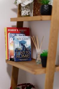 a book shelf with two books on it at City Central Garden Apartments at Benson Street in Liverpool