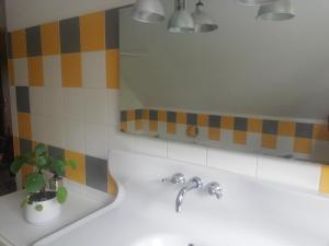 a bathroom with a sink and a mirror at Kerlot in Duault