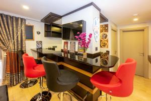 a dining room with red chairs and a table at Harmony Hotel Istanbul & SPA in Istanbul