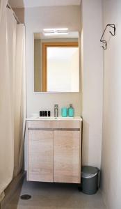 a bathroom with a sink and a mirror at Thea Apartments in Emporeios