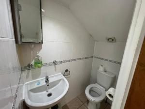 a small bathroom with a sink and a toilet at Stay in Bloomsbury1 in London