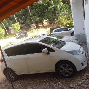 a white car parked in front of a building at Zaradise Suites in Mombasa