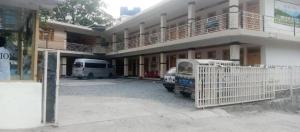 a white van parked in front of a building at Hotel Lucky Inn in Nārān