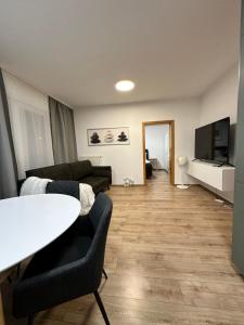 a living room with a couch and a table at IOS Garden in Prague