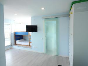 a room with a bed and a tv on a wall at Estudio Roses, estudio, 4 personas - ES-228-112 in Roses