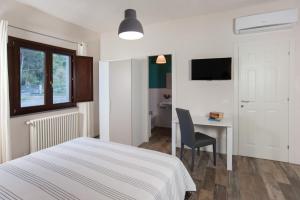- une chambre avec un lit et un bureau avec une chaise dans l'établissement B&B Vignicella, à Castelbuono