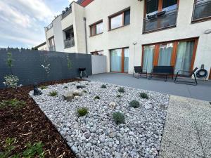 a garden with rocks and plants in front of a building at IOS Garden in Prague