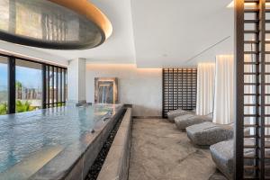 a large swimming pool with ducks in a house at Los Jardines de Abama Suites in Guía de Isora
