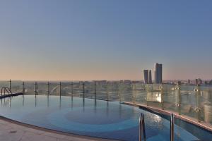 a swimming pool on the roof of a building at J 22 Residence in Lusail