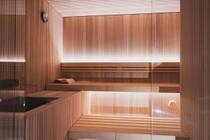 a sauna with wood paneling and a glass wall at Hotel La Gemma in Florence