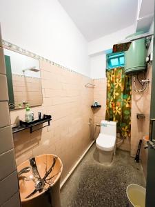 a bathroom with a toilet and a sink at StayCation Homestay in Gangtok