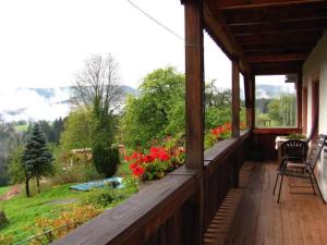 a porch of a house with flowers on it at Ferienhof Rohrbachhof in Schiltach