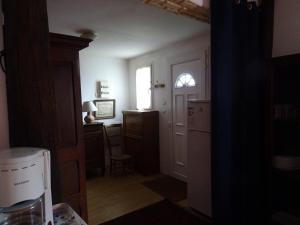 a kitchen with a refrigerator and a table and a window at chez madame cigogne in Douzy