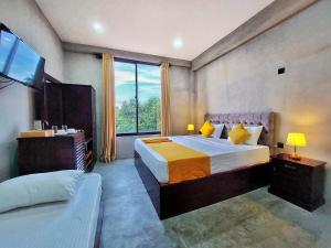 a hotel room with a bed and a large window at Catch Up Dambulla in Dambulla