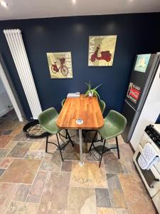 a table and chairs in a room with a blue wall at Wolf Hollow, sleeps 4 adults plus 2 children, Buxton town centre in Buxton +12 photos
