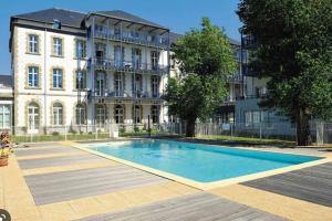 une grande piscine en face d'un bâtiment dans l'établissement Magnifique appartement plein sud - Piscine, au Croisic