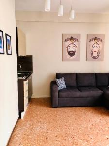 a living room with a couch and some pictures on the wall at Taormina Center Private Apartments By Fragranza Di Sicilia in Taormina +131 photos