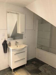 a white bathroom with a sink and a shower at Apartment Vuleta Deluxe Extra groß in Prijedor +16 photos