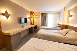 Postel nebo postele na pokoji v ubytování Aktas Hotel