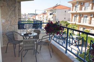 a balcony with a table and chairs on a balcony at Valeria Apartament Cozy & Quiet in Kallithea Halkidikis +6 photos