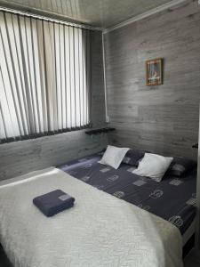 a bedroom with a large bed with two pillows on it at Apartment in Chişinău