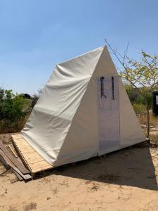 a tent is set up on the beach at BH מתחם קמפינג ואוהלים in Nevatim