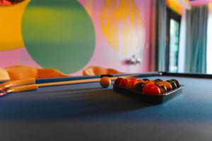 a tray of billiard balls on top of a pool table at Capsule Flora business bay view Burj Khalifa-pool table-game arcade-Projector-Playstation 5 in Dubai