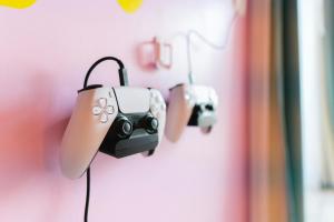 a couple of cameras hanging on a wall at Capsule Flora business bay view Burj Khalifa-pool table-game arcade-Projector-Playstation 5 in Dubai