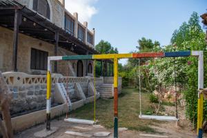 a swing set in front of a building at Zad El Mosafer Guest House in Tunis