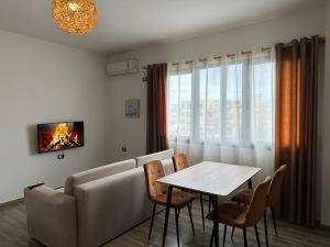 a living room with a couch and a table at Sea View Deluxe Apartment in Durrës