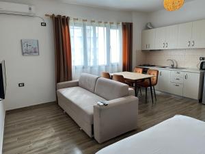 a living room with a couch and a table at Sea View Deluxe Apartment in Durrës
