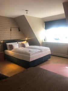 a bedroom with a bed and a window at Strandvogtei Sylt in Rantum