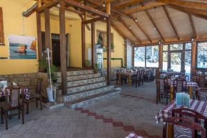 a restaurant with tables and chairs in a building at Kod Goluba na Tari in Šljivovica