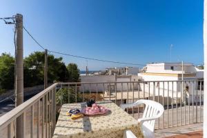 a table and chairs on a balcony with a view at Appartamento a 150 mt dal lungomare in Leuca