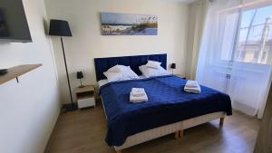 Łóżko lub łóżka w pokoju w obiekcie La Mer Pokoje i Apartamenty