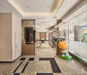 a hallway in a building with a lobby at Orange Hotel - Linsen, Taipei in Taipei