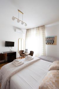 a bedroom with a bed with two chairs and a desk at Soggiorno La Coccinella in Florence